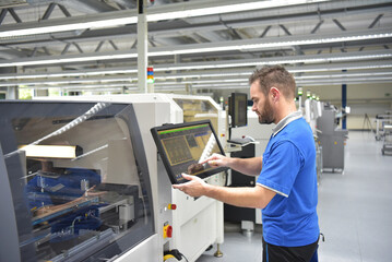 engineering in microelectronics: workers in the production and assembly of electronic high tech components in a modern factory