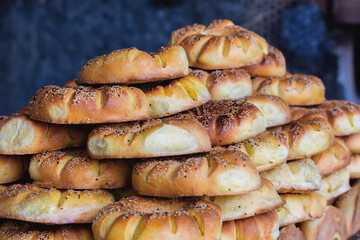 Close-up of a stack of traditional Uzbek bread topped with sesame seeds, freshly baked with a golden crust, showcasing the texture and details. Tashkent, Uzbekistan