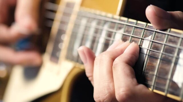 Guitar solo. A musician is practicing guitar soloing techniques. Close-up and slow motion.