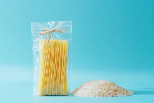 A bag of rice and a bag of pasta are displayed on a blue background