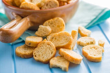 Sliced roasted bruschetta bread on blue table.