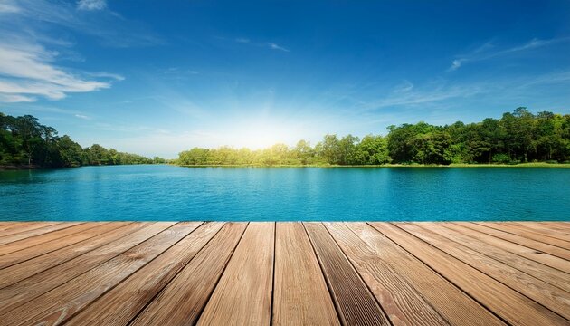 wooden floor against blue sky over lake with trees in the background