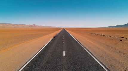 Long straight road stretching into distant desert landscape with blue sky and barren terrain on either side
