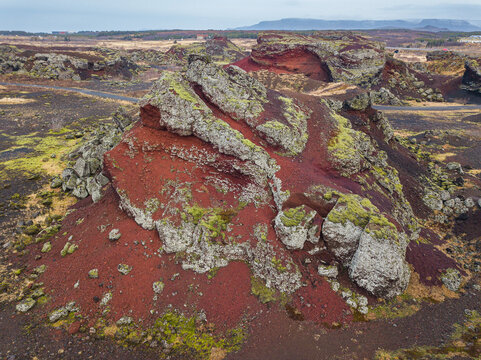 Red hill of a pseudocrater in the Raudholar region, which contains a cluster of rootless cones, also called pseudocrater