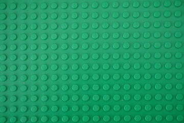 Naklejka premium Green plastic Lego board