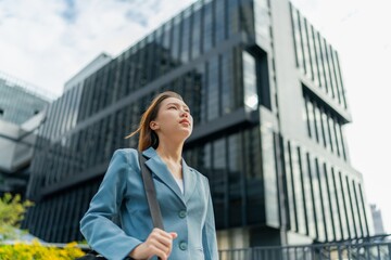 Portrait of a young and confident businesswoman standing in front a modern office building in the financial district