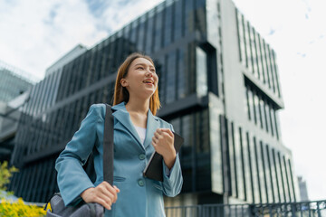 Young Asian Businesswoman Using Digital Tablet While On The Way To The Office In The Morning