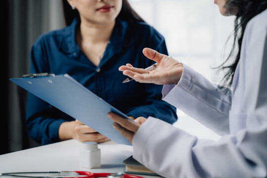 Doctor Patient Consultation:  A close-up shot of a doctor and patient engaged in a serious, focused discussion, reviewing medical documents.  The image exudes trust, care, and professionalism. 