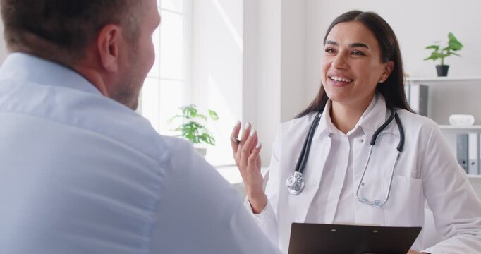 Female doctor or nurse holds a medical appointment with a patient in a hospital office visit. The healthcare provider offers medical care, support, and guidance to ensure the patient well-being.