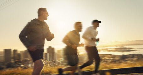 Men, fitness and running with sunset or speed for exercise or outdoor training together on mountain. Active, male people or runners with motion blur for sprint, race or health and wellness in nature
