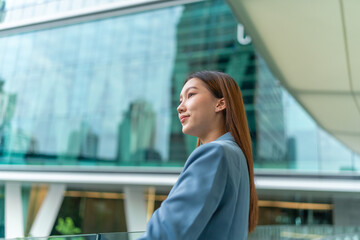 Portrait of a young and confident businesswoman standing in front a modern office building in the financial district