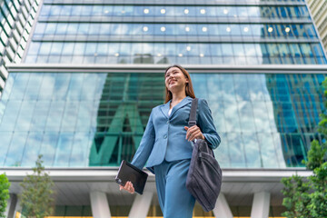 Portrait of a young and confident businesswoman standing in front a modern office building in the...