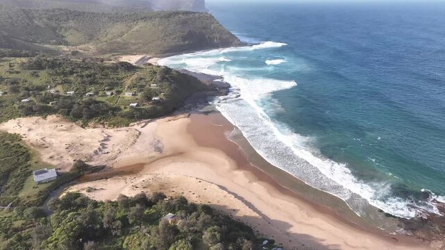 Burning Palms Beach drone flight along the escarpment and empty coastline, Royal National Park, NSW Australia
