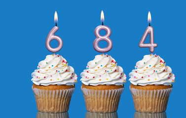 Birthday Cupcakes With Candles Lit Forming The Number 684