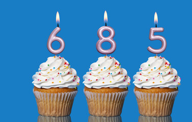 Birthday Cupcakes With Candles Lit Forming The Number 685
