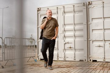 Caucasian Man posing in front of industrial background in Albufeira - Portugal