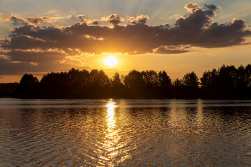 the lake with orange water in the summer at sunset