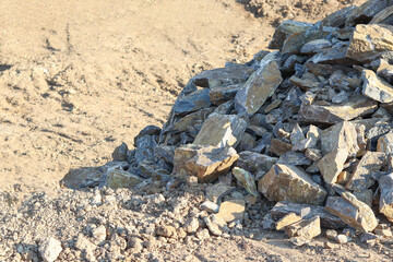 A close-up shot of rocks on dry ground,A pile of stones on clay.Perfect for nature, geology, and outdoor concepts.Construction site, . High quality photo