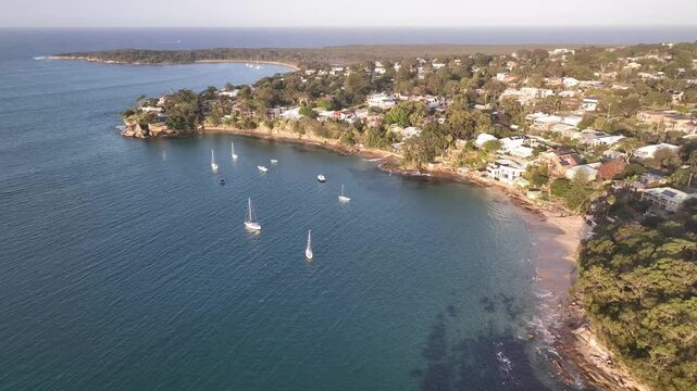 Simpsons Bay aerial drone footage over moored boats and calm water, Bundeena, Royal National Park, NSW Australia
