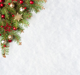 Christmas and New Year background.  Christmas tree branches with  decorations on the background of natural snow with empty space for text.  Flat lay.