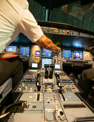 Photography of a control panel in an airplane with all the buttons, commands and screams on. after landing during a rainy night