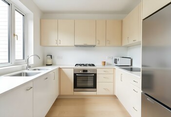 Fototapeta premium A modern kitchen with white walls, light wood cabinets, and stainless steel appliances. The kitchen has a minimalist and clean design