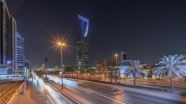 Panoramic aerial night timelapse of Riyadh featuring highway traffic, Kingdom Tower the tallest skyscraper and landmark of Saudi Arabia's capital. Illuminated modern buildings surround vibrant scene
