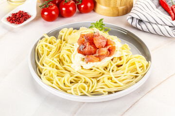 Pasta spaghetti with salmon and stracciatella