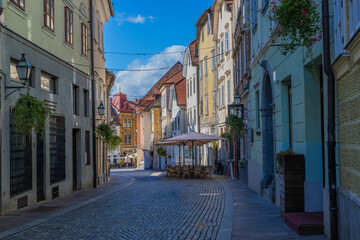 stari trg Ljubljana, Slovenia without visible people and very colorful with a blue sky and clean street. Central europe