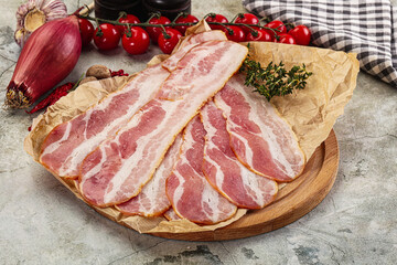 Sliced pork bacon over board