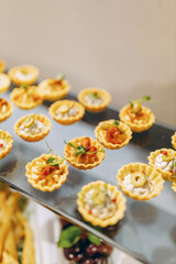 Small tartlets with tomato paste and olives, small appetizers, savory snack, luxury restaurant, fashionable food