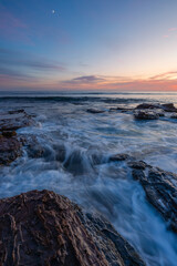 Dawn view on the rocky shore coastline.
