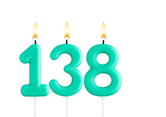 Green birthday candle on white background - Candle number 138