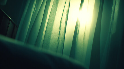 Sunlight streams through sheer curtains in a bedroom, casting a warm glow on the bed.