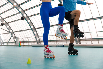 A man and woman on roller skates, enjoying an active and fun moment together. Perfect for themes of...