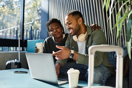 A couple discusses their travel plans while relaxing in the hotel lobby, enjoying each other's company.