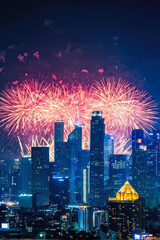Naklejka premium Vibrant fireworks illuminate the night sky above a glowing cityscape, celebrating New Year's Eve with energy and color. Generative AI