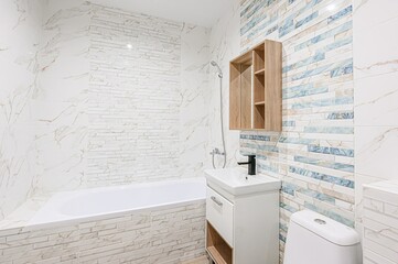 bright bathroom with white marble contemporary toilet and sink.  wooden shelf adds warmth,subtle...