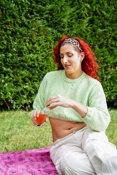 Trans woman enjoying a picnic in nature, relaxed and joyful