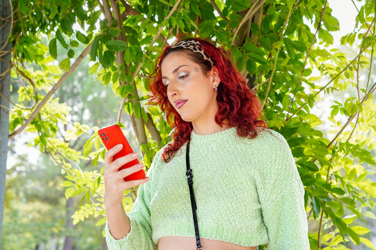 Confident Trans Woman Enjoys Outdoor Time with Smartphone