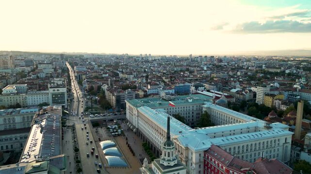 Aeriah helicopter footage of the bulgarian national flag atop of the National Assembly governmental building in Sofia the capitol of Bulgaria. Drone shot of European patriotism display in a city.
