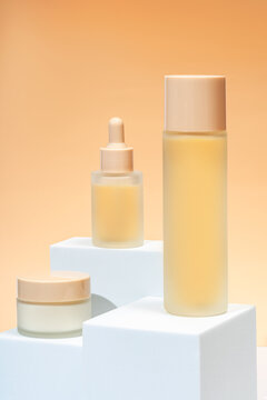 Elegant cosmetic packaging set displayed on pedestals