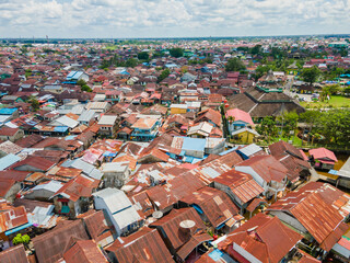 Rooftops of houses that are crowded together in a densely populated area on the banks of the Kapuas...