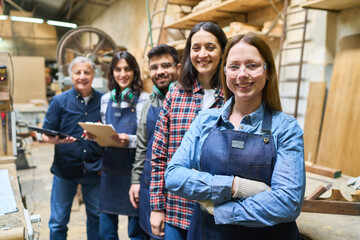Diverse team working together in a busy lumberyard workshop