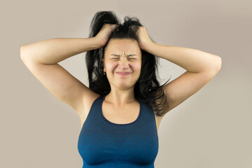 Fototapeta premium Disappointed and irritated woman with closed eyes holding her head, isolated on white background.