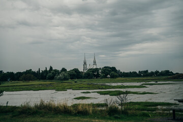 After a rainy day, fiery sunset over the St Lawrence river at the Pointe au Pere Lighthouse in Rimouski, Quebec