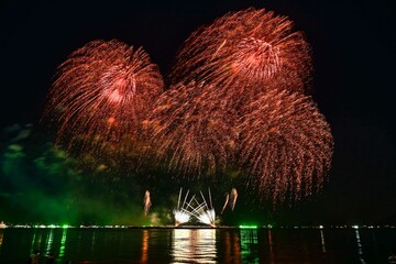 Beautiful fireworks set off in the middle of the sea.