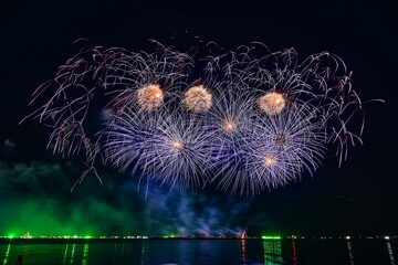 Beautiful fireworks set off in the middle of the sea.