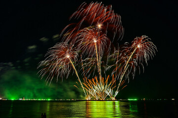 Beautiful fireworks set off in the middle of the sea.