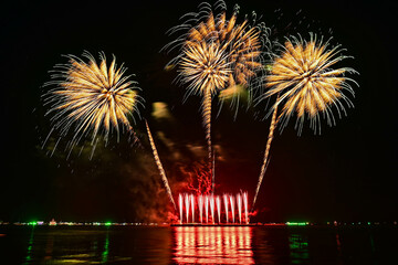 Beautiful fireworks set off in the middle of the sea.